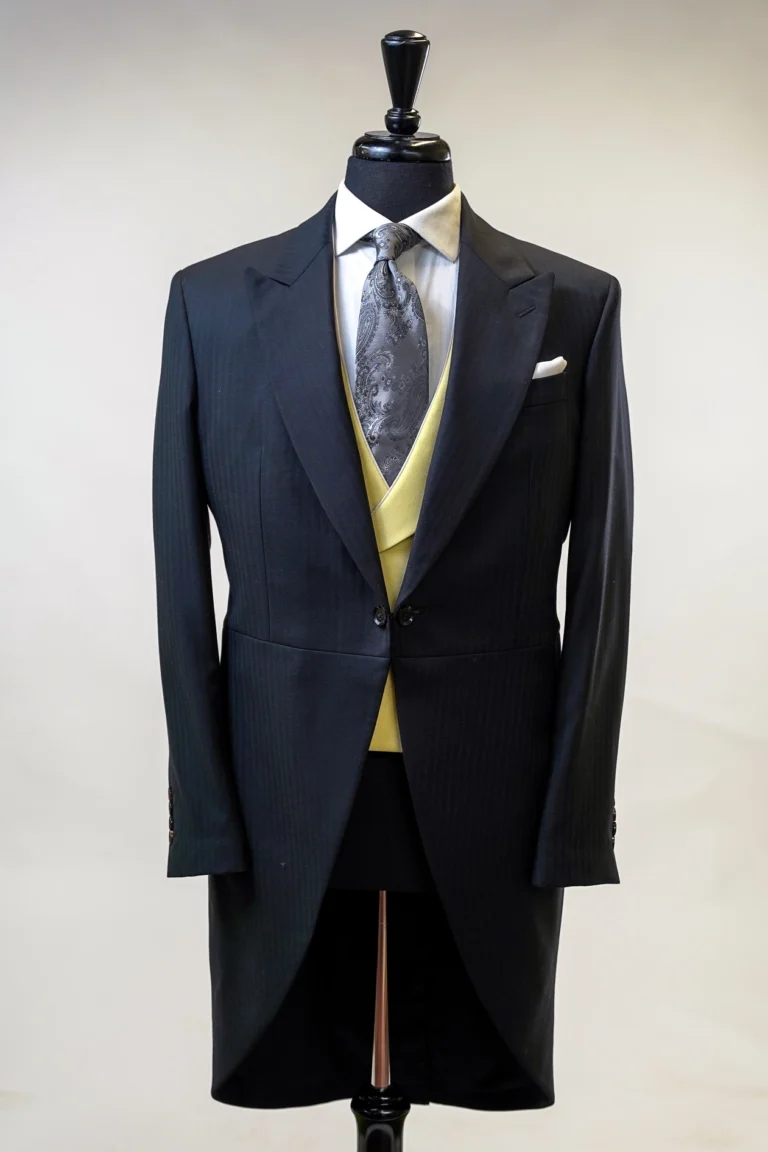 Black morning suit with a yellow waistcoat on a mannequin